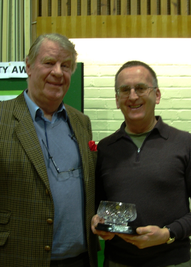 Ray Keppler (R) presents Patrick Holden with a crystal bowl with inscribed base